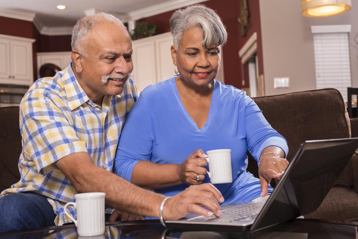 Senior couple using laptop together