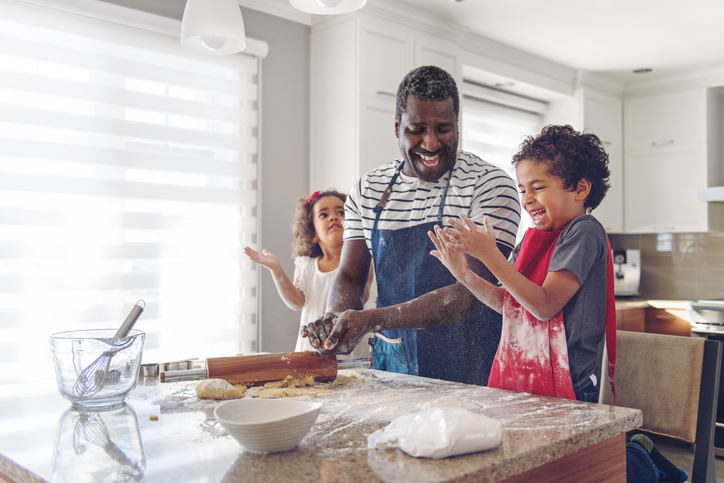 dad and two kids cooking in the kitchen