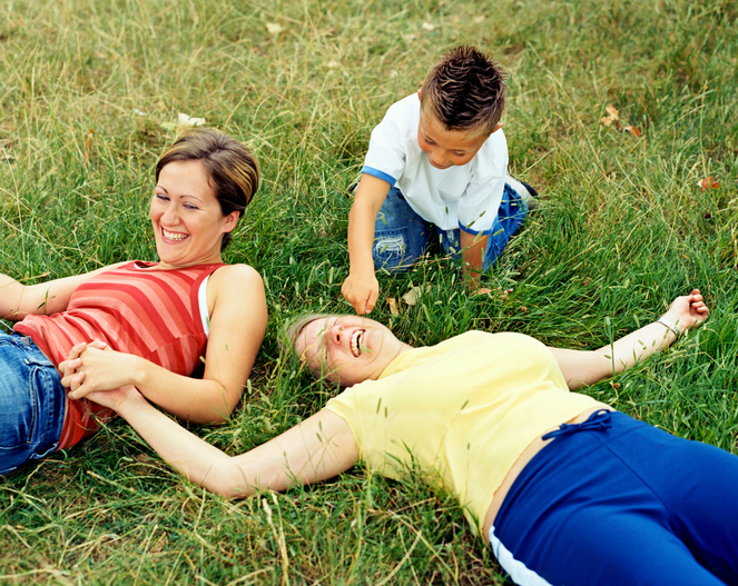 Two moms and their son playing