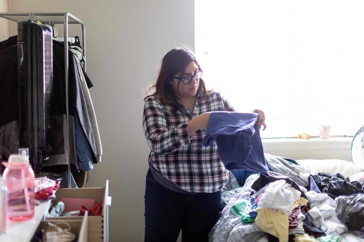 woman organizing her clothing drawers