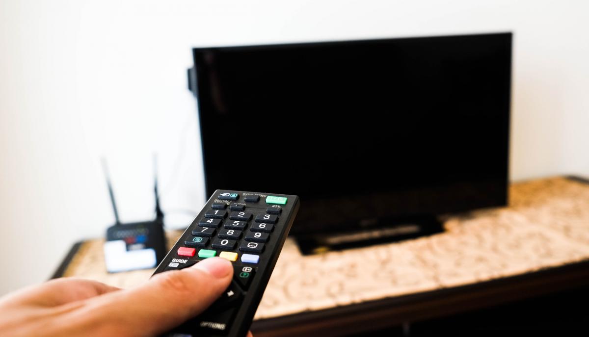 remote control pointed at a TV that is off