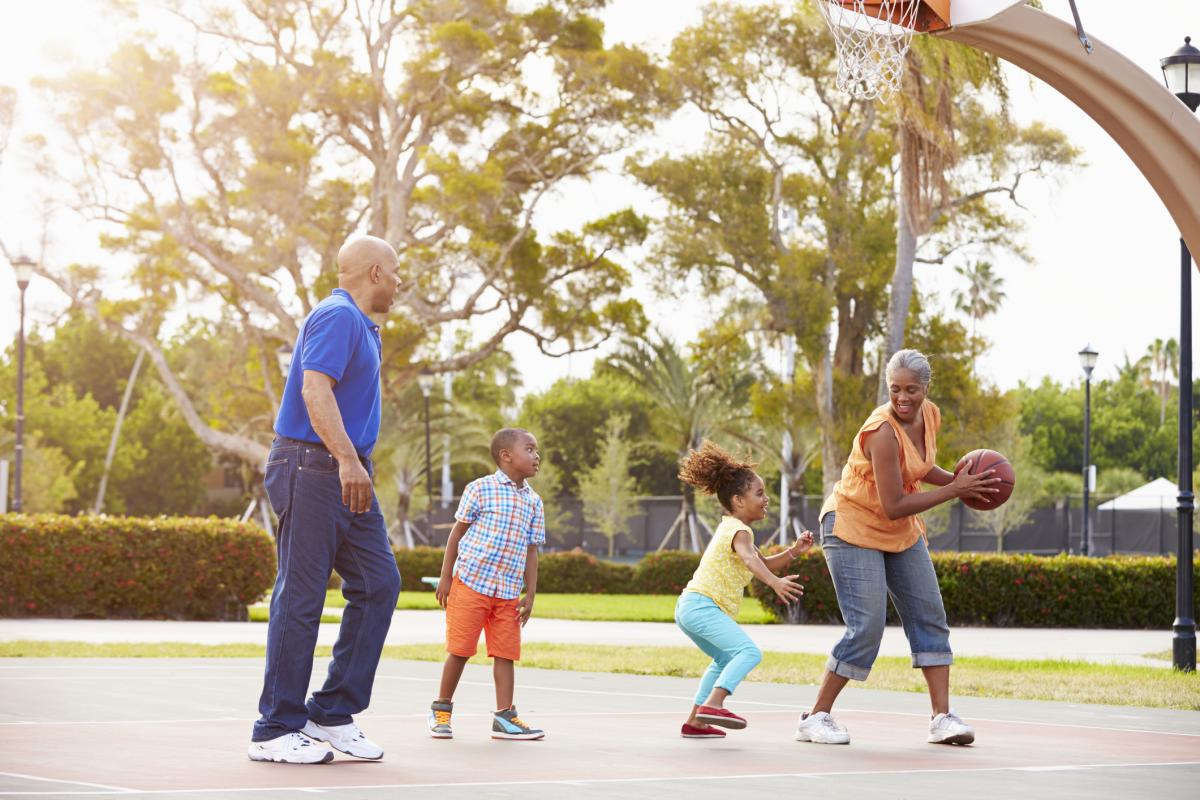 Grandparents playing basketball with grandkids