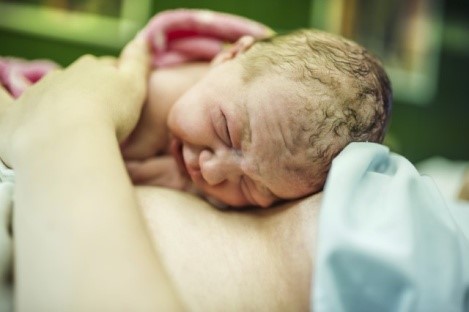 Mother holding newborn skin-to-skin