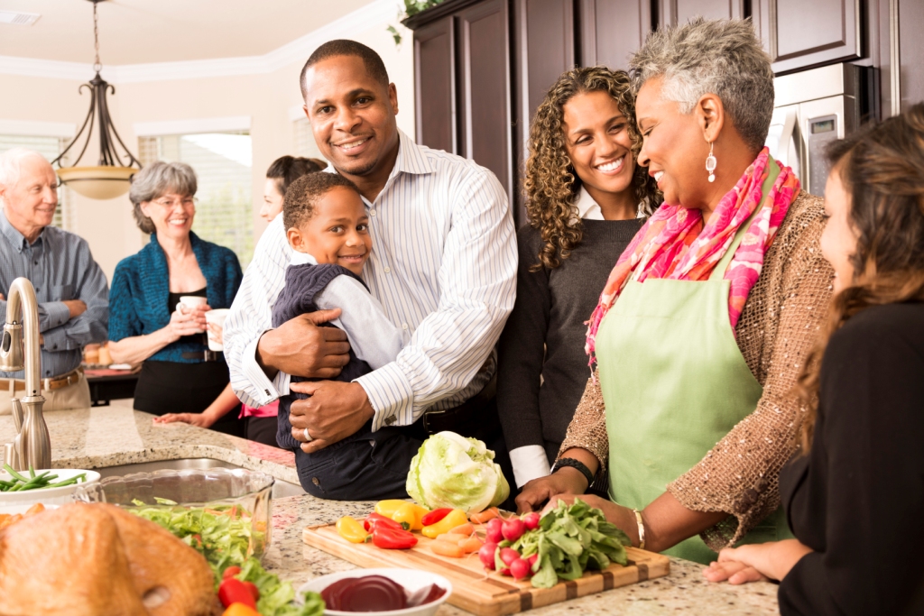 A multi-generational family cooking in the kitchen