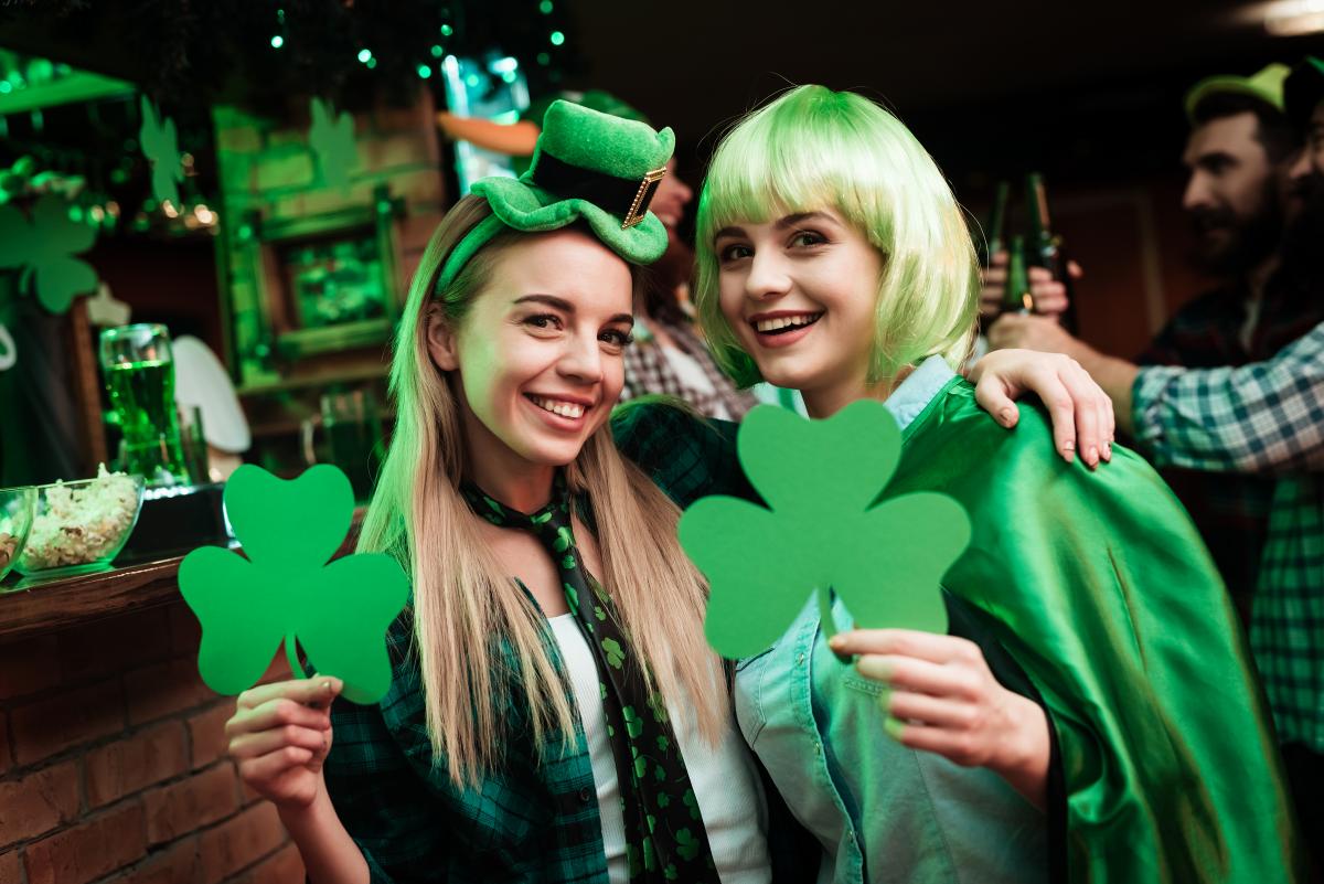 Two women enjoy St. Patrick's Day at a pub.