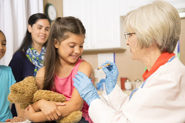 health professional giving an immunization to a child