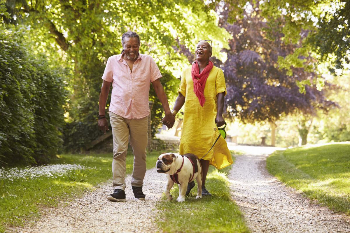 Couple walking a dog on a leash