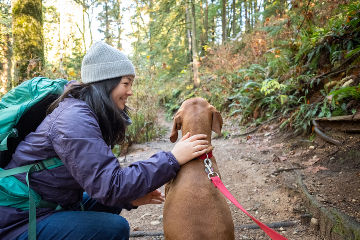 Woman and her dog in the forest