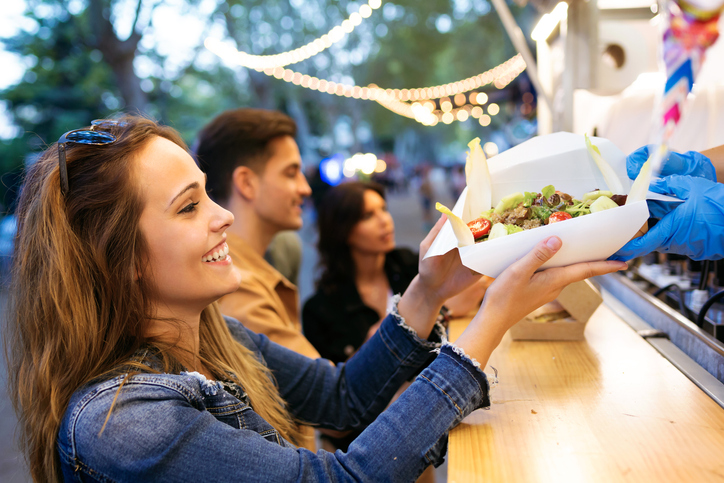 Woman getting food from an outdoor food truck