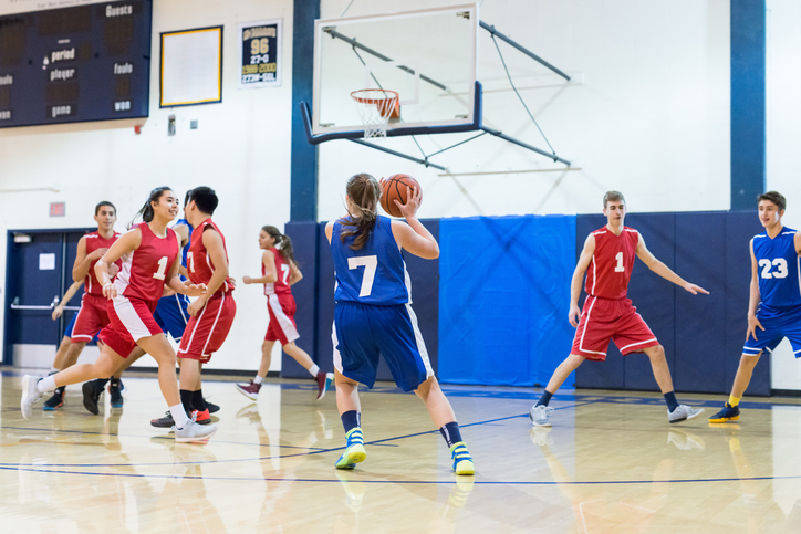 Teens playing basketball