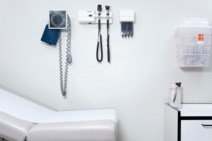 Medical exam room with blood pressure checker on the wall