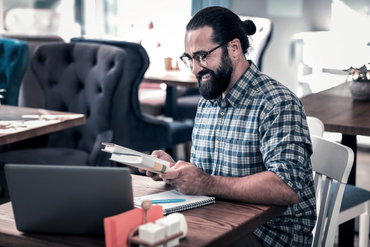 Restaurant owner reviewing his menu in a cafe