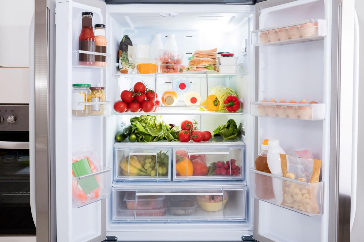 A well-stocked fridge with both doors wide open