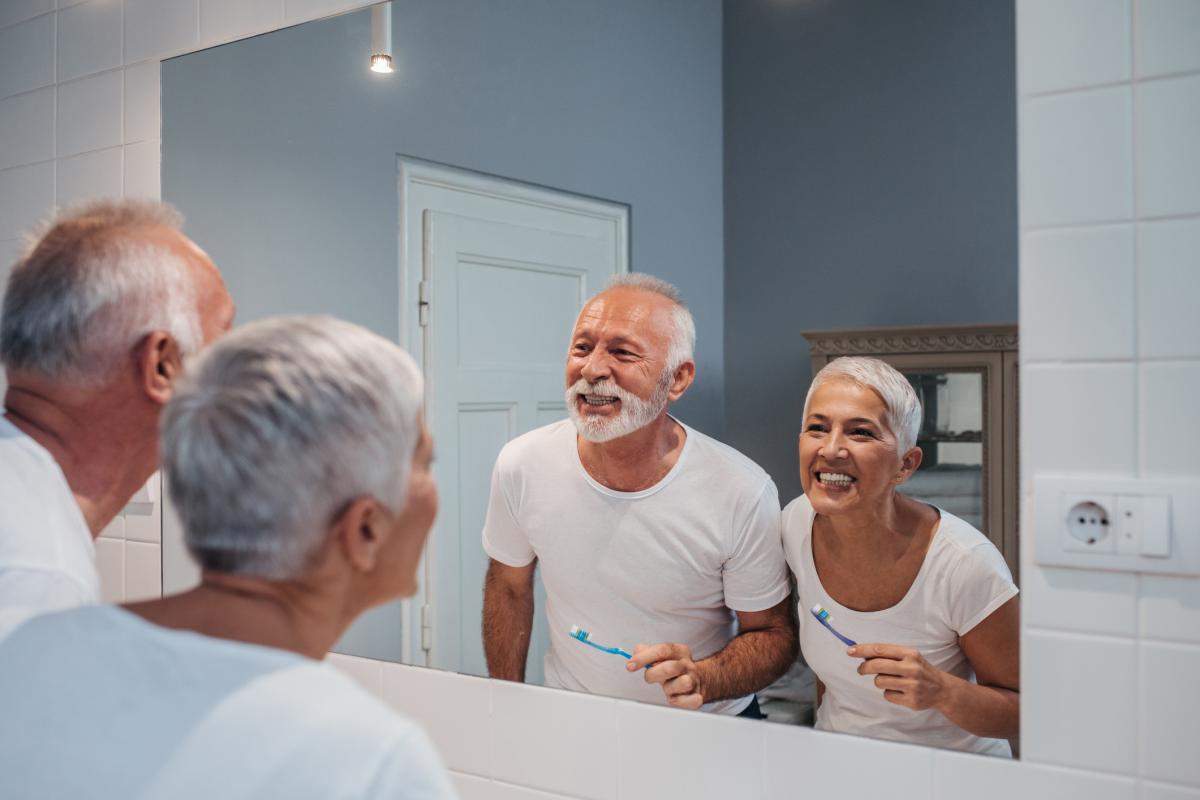 Senior couple brushing their teeth together