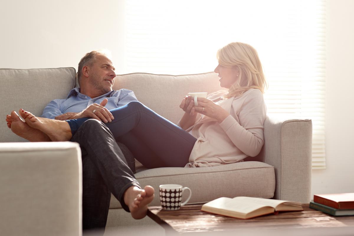 Husband and wife talking on couch