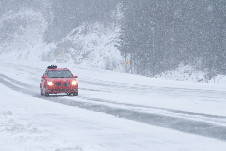 Car driving on snowy winter road