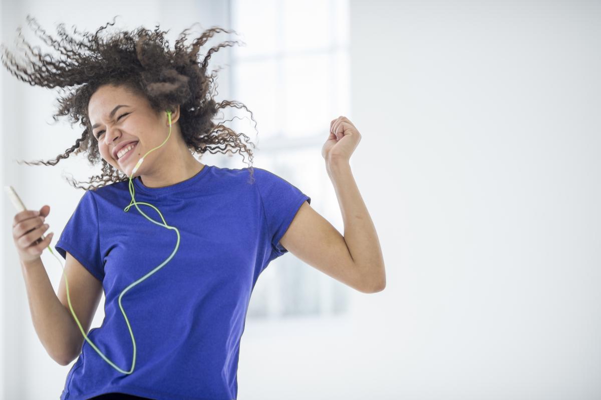 Young woman dancing to music