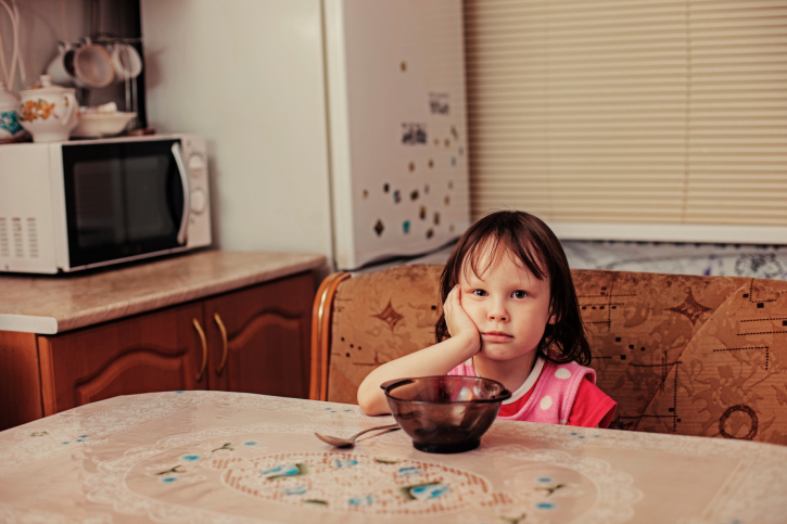 Young girl sitting at table