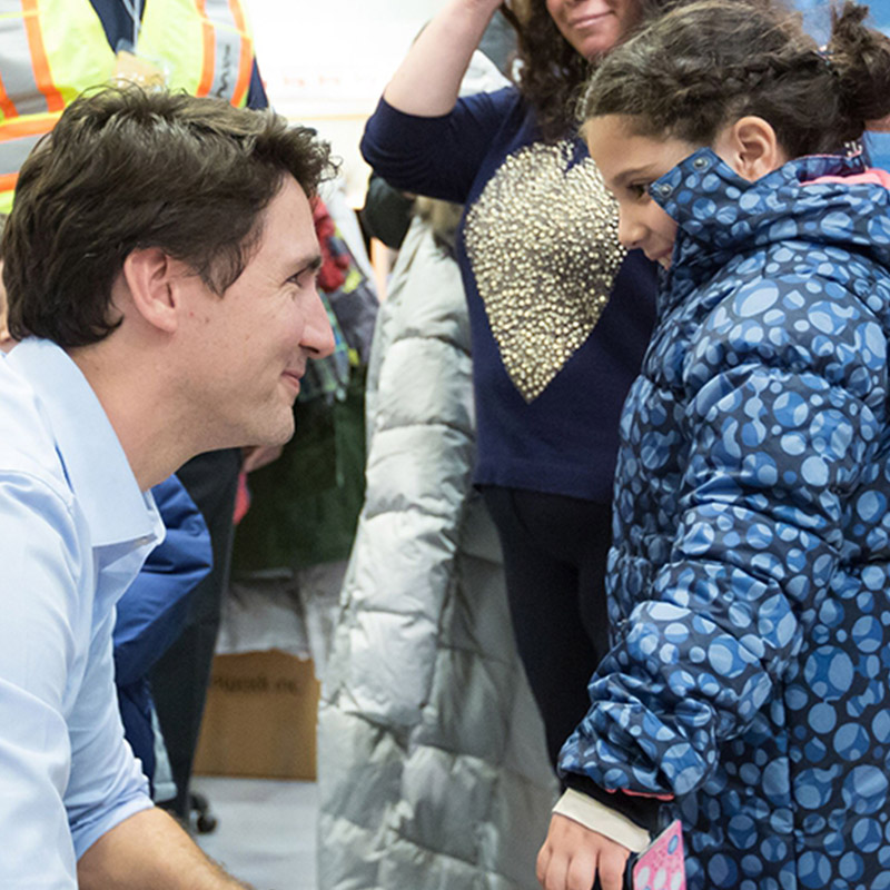 Justin Trudeau welcoming refugee