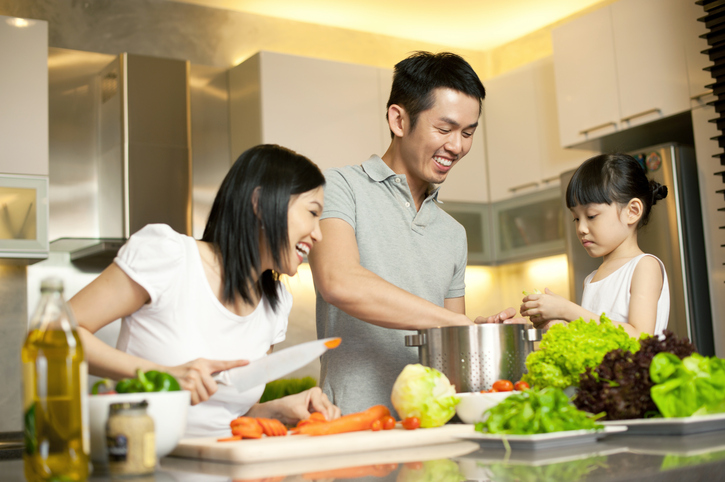 Family cooking together in kitchen