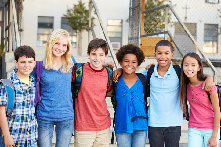 Kids wearing backpacks outside school