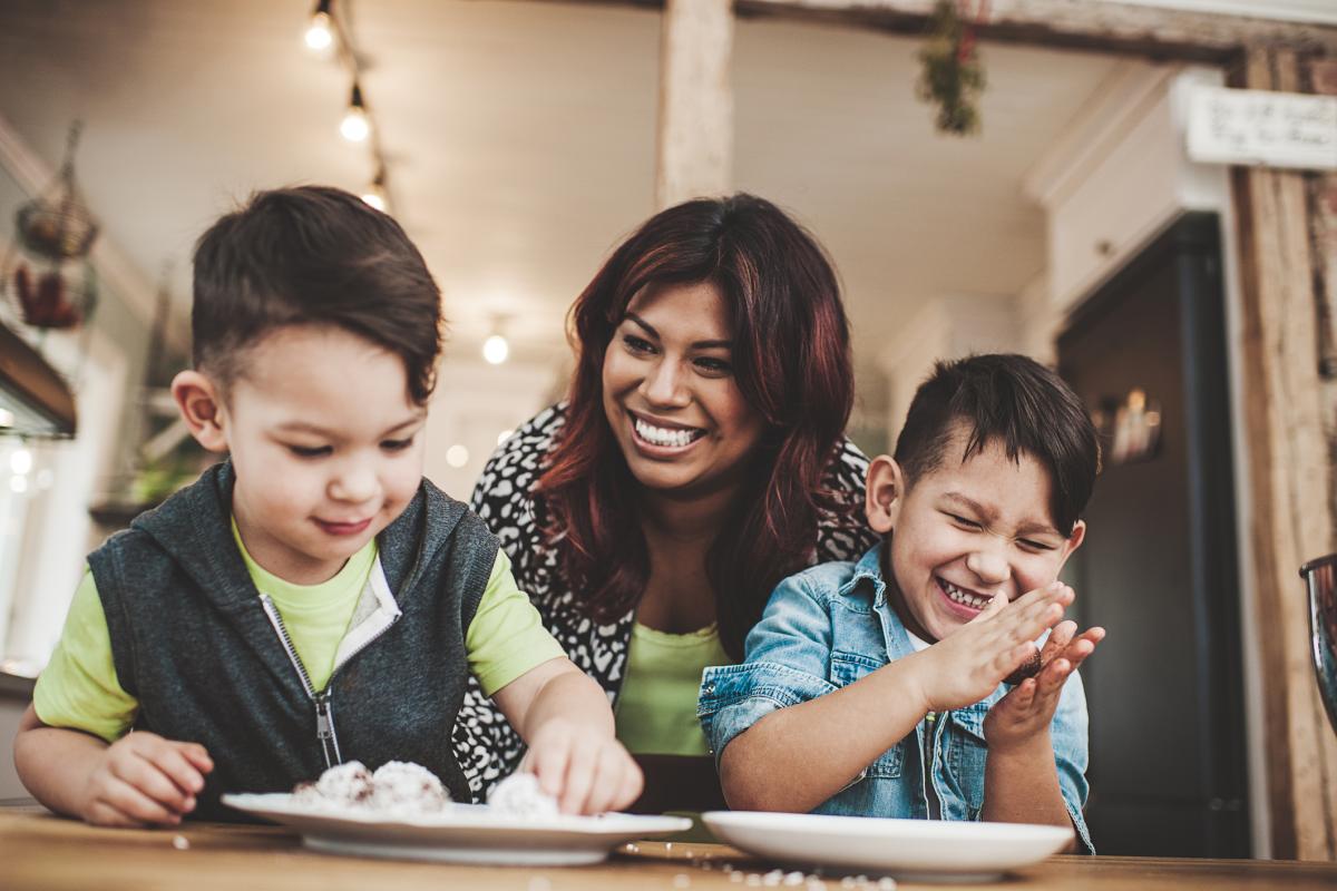 Mom and two sons cooking together