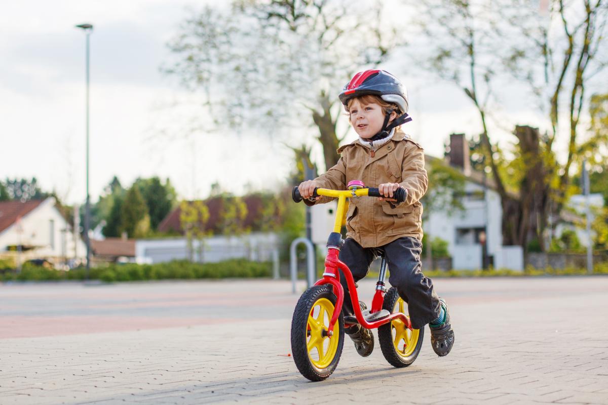 Young boy with helmet riding bicycle
