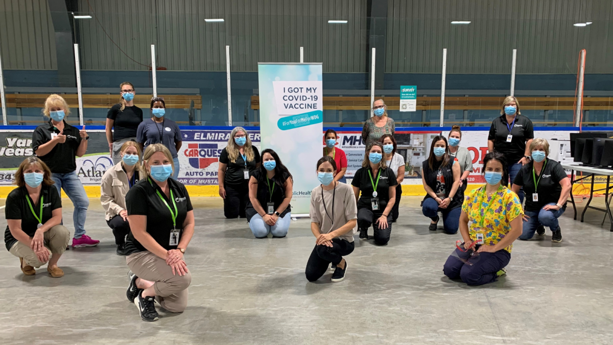 Group of staff in the Centre Wellington Community Sportsplex vaccination clinic.