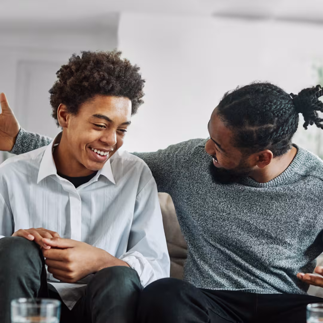 Father and teen son having a chat on the couch
