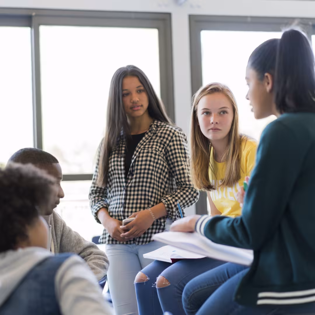 group of teens chatting in class