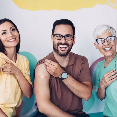 Child care workers pointing at bandaids on their arms
