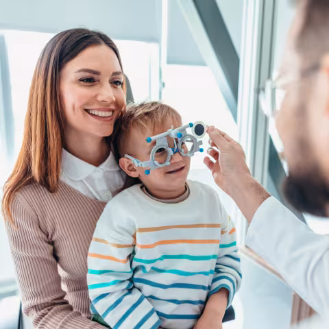 Mother and Child at Eye Appointment with an Optometrist