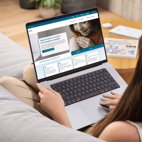 Woman on couch looking at laptop screen