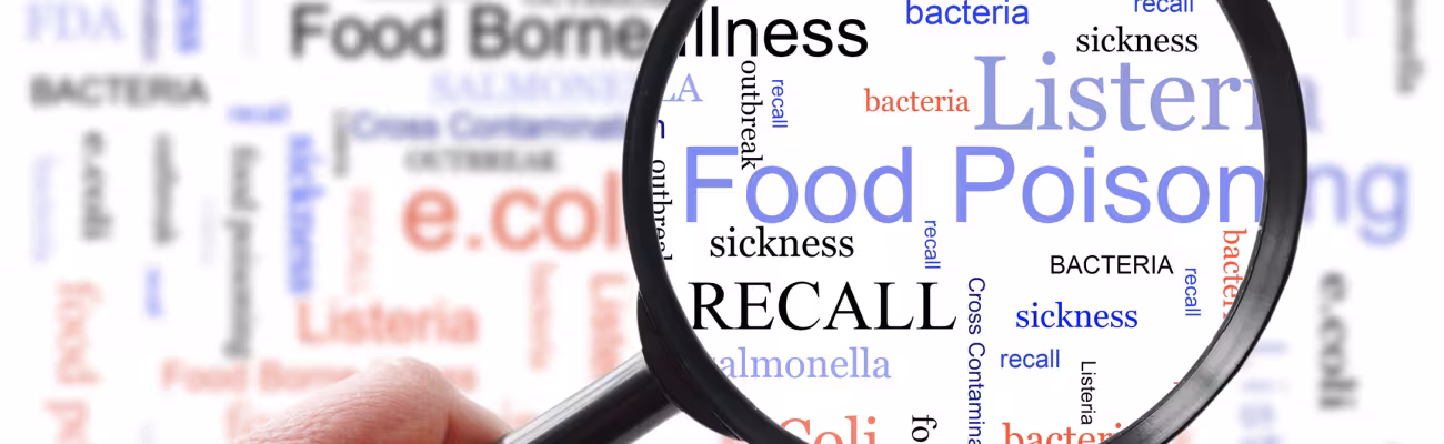 Food poisoning related terms, salmonella, e coli etc, in a word cloud with magnifying glass