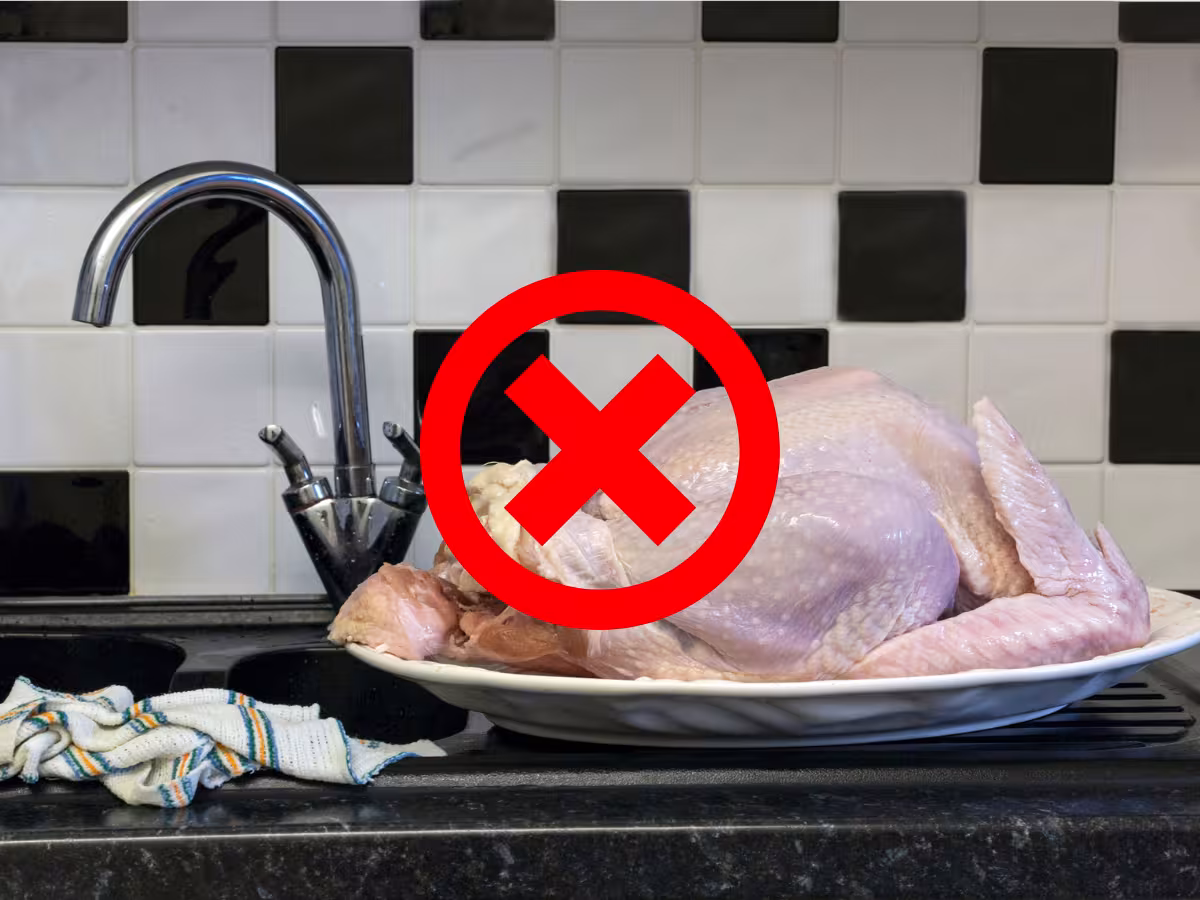 Raw turkey beside a sink on the counter