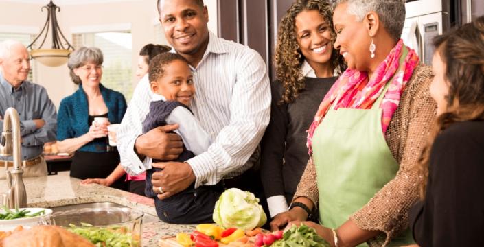 Multigenerational family cooking a holiday meal together