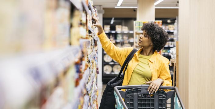 Customer choosing products in supermarket while grocery shopping