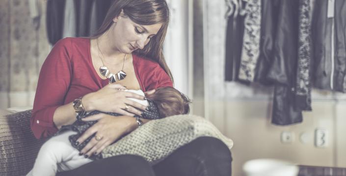 Woman breastfeeding in a clothing store