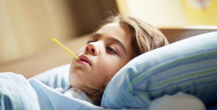 Girl lying sick in bed