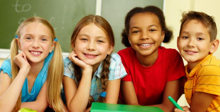Group of children in classroom smiling