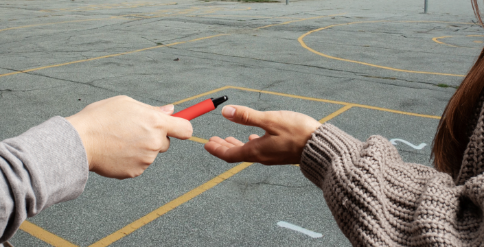 Teens sharing vapes at school
