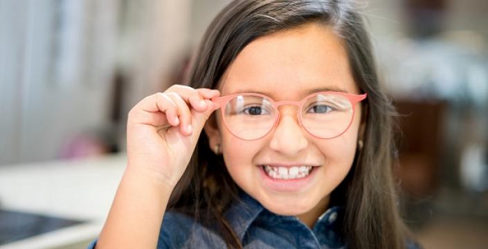 Junior Kindergarten girl showing off her new glasses