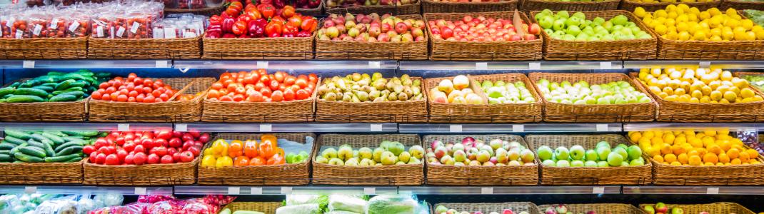 Colourful fruits and vegetables stacked decoratively in a store