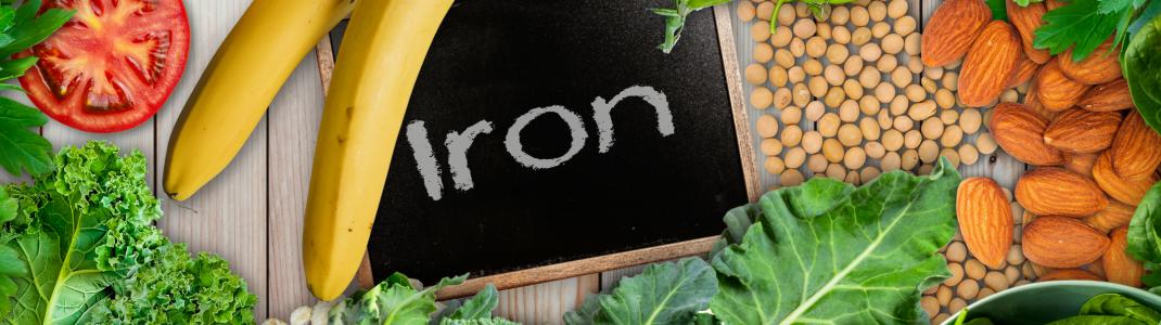 Plant based sources of iron background. broccoli, banana, tomatoes, almond, spinach, green peas, collards, grapes, kale, soya been and nuts are iron-rich foods. - stock photo