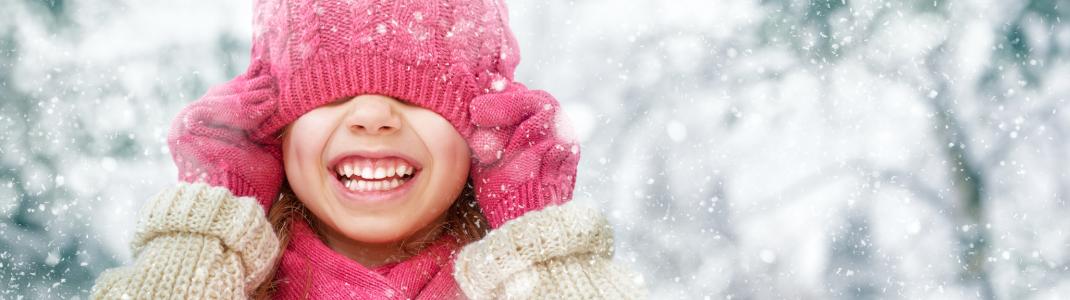 Young girl wearing winter clothes on snowy day