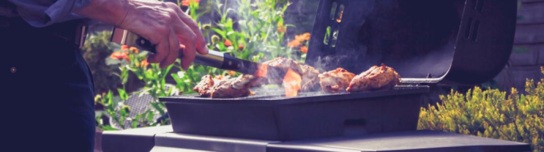 Man grilling meat on barbeque