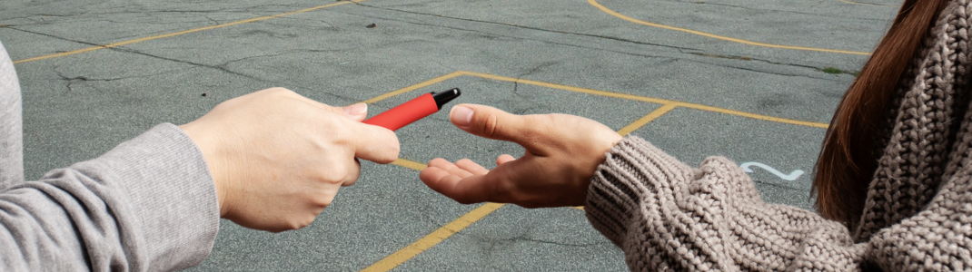 Teens sharing vapes at school