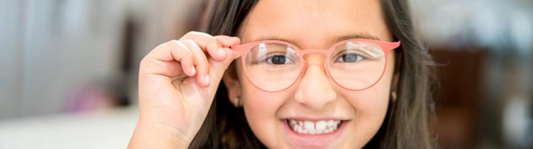 Junior Kindergarten girl showing off her new glasses