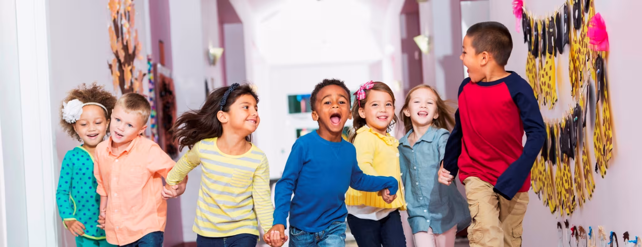 Happy group of children in school hallway