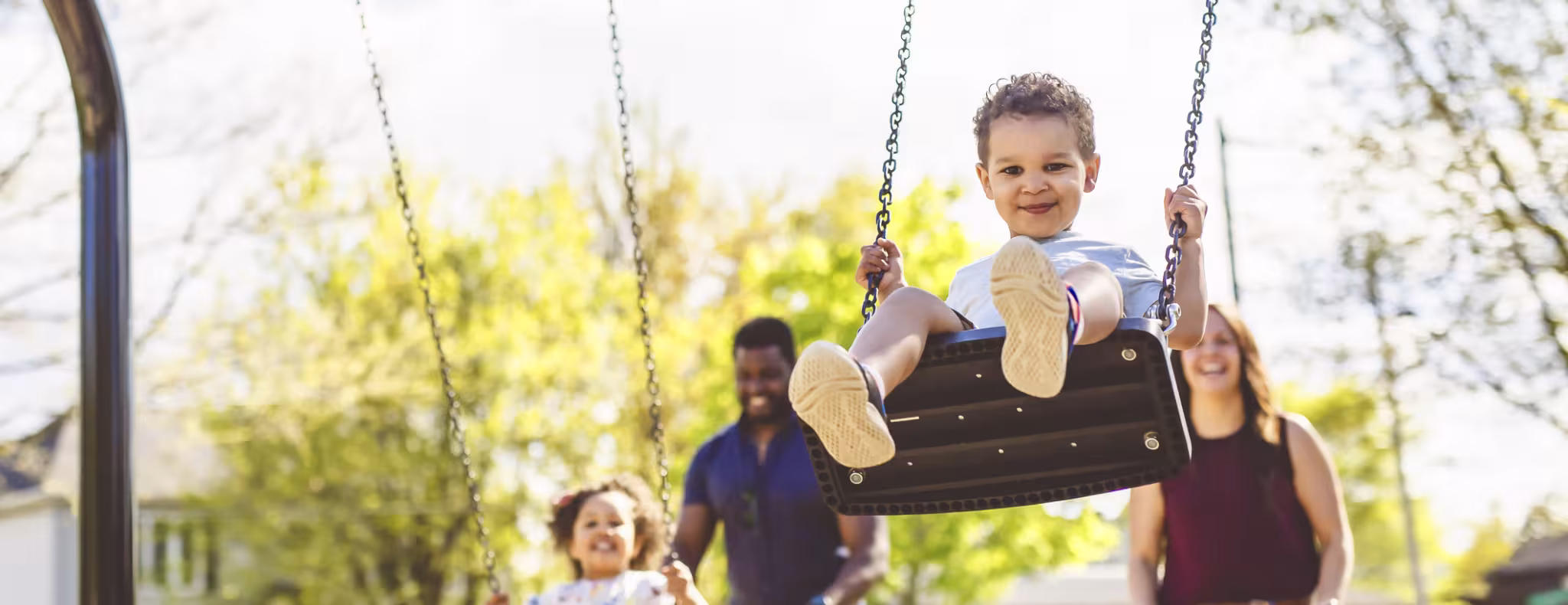 Playtime Moments. family With child Swinging Having Fun on the Playground Outside, 